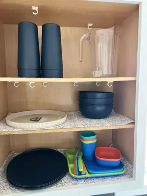 a cupboard with bowls and plates and utensils at Newly renovated home, Fire pit, Games, Grill in Tobyhanna