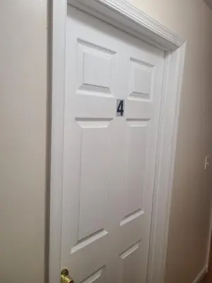 a white door with the number four on it at Amazing family house in Newark