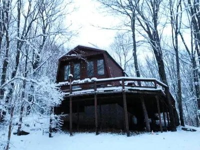 a cabin in the woods with snow on it at Peaceful Tree House Nestled Away in Hudson Valley, New York in Carmel Park Estates