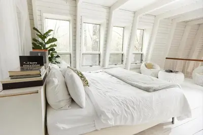 a white bedroom with a bed and windows at Peaceful Tree House Nestled Away in Hudson Valley, New York in Carmel Park Estates