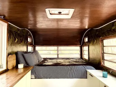 a bedroom with a bed in the middle of a room at Romantic Glamping Getaway in a Pet Friendly Caravan, Ideal to Explore Hudson Valley in New Forge