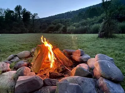 a camp fire in a pile of rocks at Homey Pet-Friendly Cabin Rental for Groups in the Catskills in Big Indian