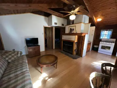 a living room with a couch and a coffee table at Simple Cabin Camping for Families in the Catskills of Upstate New York in Big Indian