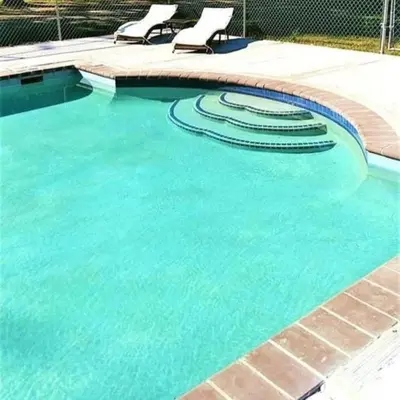 a swimming pool with two lounge chairs in it at Simple Cabin Camping for Families in the Catskills of Upstate New York in Big Indian