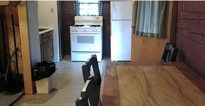 a kitchen with a stove and a white refrigerator at Rustic Cabin Rental for Groups near Woodstock, Upstate New York in Big Indian
