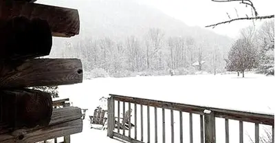 a wooden bench sitting next to a snow covered field at Rustic Cabin Rental for Groups near Woodstock, Upstate New York in Big Indian