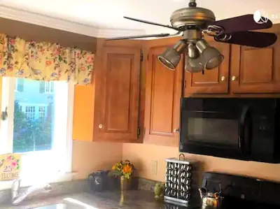a kitchen with a ceiling fan and a microwave at Peaceful and Pet-Friendly Cottage Rental on Picturesque Country Estate near Black Rock State Park, Connecticut in Watertown