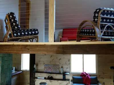 two chairs and a table in a room at Charming Cabin Getaway with a Wood-Burning Stove in Chesterfield, Massachusetts in Chesterfield