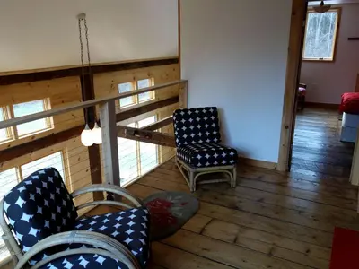 a living room with two chairs and a table at Charming Cabin Getaway with a Wood-Burning Stove in Chesterfield, Massachusetts in Chesterfield