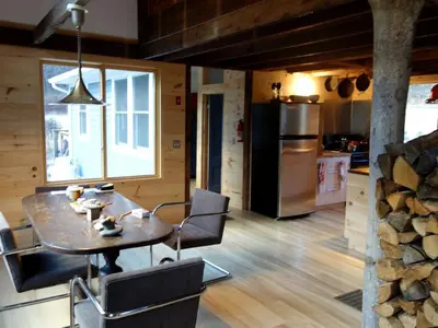 a kitchen and dining room with a table and chairs at Charming Cabin Getaway with a Wood-Burning Stove in Chesterfield, Massachusetts in Chesterfield