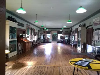 a large room with wooden floors and pendant lights at Vintage Caboose Rental in Historic Small Town near Springfield, Massachusetts in Chester