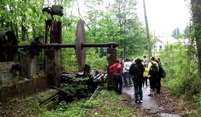 a group of people walking down a trail at Vintage Caboose Rental in Historic Small Town near Springfield, Massachusetts in Chester
