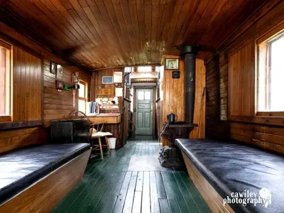 a train room with wooden walls and wooden floors at Vintage Caboose Rental in Historic Small Town near Springfield, Massachusetts in Chester