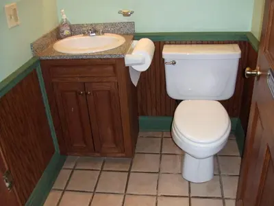 a bathroom with a toilet and a sink at Vintage Caboose Rental in Historic Small Town near Springfield, Massachusetts in Chester