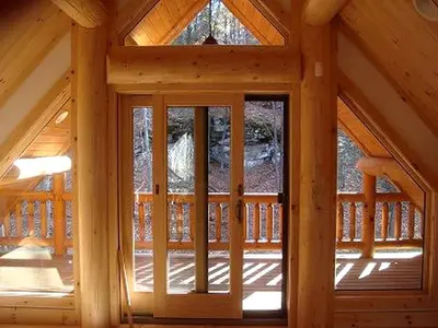 a wooden cabin with a large glass door at Rustic Log Cabin in the Catskills, Upstate New York in Olivebridge
