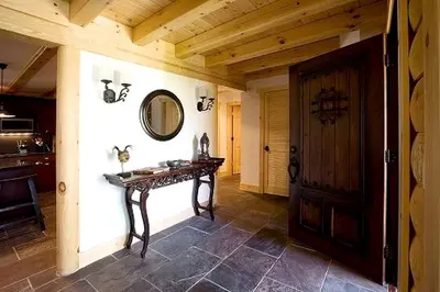 a hallway with a table and a mirror on the wall at Rustic Log Cabin in the Catskills, Upstate New York in Olivebridge
