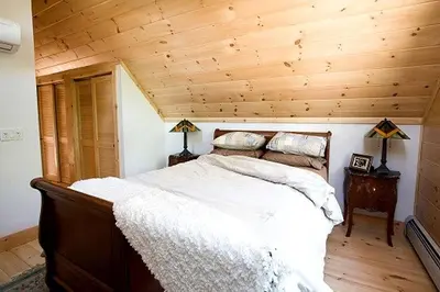 a bed in a room with a wooden ceiling at Rustic Log Cabin in the Catskills, Upstate New York in Olivebridge