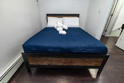 a teddy bear sitting on a bed in a room at Hudson Haven-Near NYC Transit in West New York