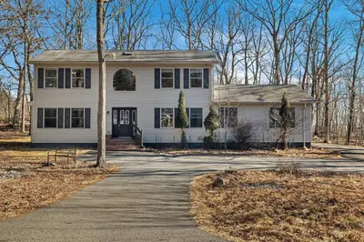 a white house with a tree in front of it at Home in Bushkill Saw Creek Poconos area in Saw Creek