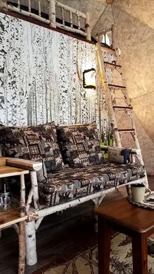 a couch sitting in a room next to a table at Romantic Glamping Dome in the Catskill Mountains near Woodstock, New York in Hensonville