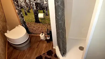 a bathroom with a toilet and a shower at Romantic Glamping Dome in the Catskill Mountains near Woodstock, New York in Hensonville