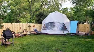 a tent in a yard next to a fence at Romantic Glamping Dome in the Catskill Mountains near Woodstock, New York in Hensonville