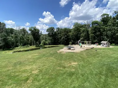 a large field with a picnic table and a playground at Lovely Bell Tent for Memorable Glamping Weekends in Conneticut