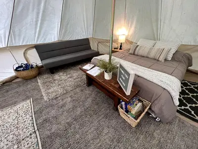 a room with a bed and a table in a tent at Lovely Bell Tent for Memorable Glamping Weekends in Conneticut