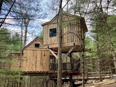 a tree house in the middle of the forest at Eco-Friendly, Abstract Treehouse Surrounded by Wildlife and Hiking Trails For a Special Getaway in Sparrow Bush, New York in Sparrow Bush