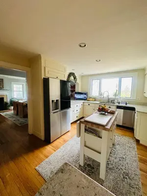a kitchen with a refrigerator and a table in it at Luxury Estate Elegant Private The White Lion Manor in Middletown
