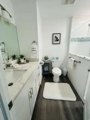 a white bathroom with a toilet and a sink at Connecticut Waterfront Home, With Hot Tub, Cozy in Rocky Hill