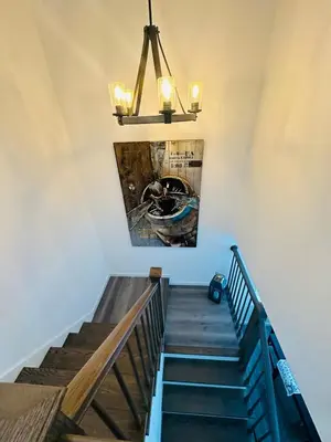 a stairway with a painting of a boat on the wall at Connecticut Waterfront Home, With Hot Tub, Cozy in Rocky Hill