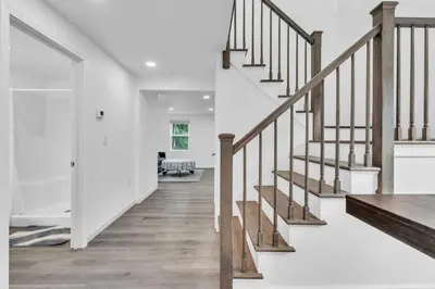 a staircase in a home with white walls and wood floors at Connecticut Waterfront Home, With Hot Tub, Cozy in Rocky Hill