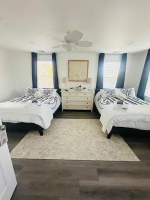 a room with three beds and a dresser in it at Connecticut Waterfront Home, With Hot Tub, Cozy in Rocky Hill