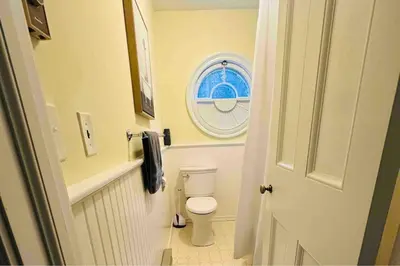 a small bathroom with a toilet and a window at Luxury Estate Elegant Private The White Lion Manor in Middletown