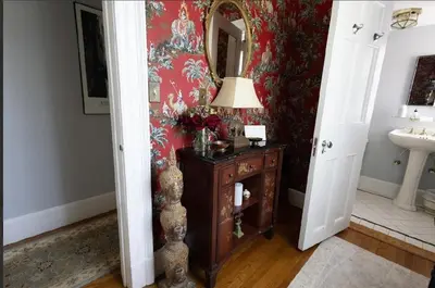 a bathroom with a mirror and a table with a lamp at Luxury Estate Elegant Private The White Lion Manor in Middletown