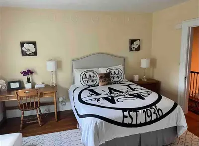 a bedroom with a bed and a desk and a chair at Luxury Estate Elegant Private The White Lion Manor in Middletown