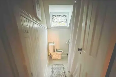 a bathroom with a toilet and a door with a window at Luxury Estate Elegant Private The White Lion Manor in Middletown