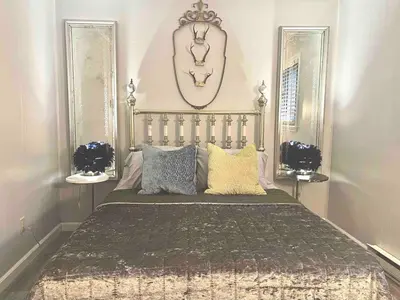 a bedroom with a large bed with pillows at Romantic Chalet Hot Tub Near Hunter Mountain in Tannersville