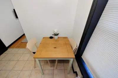 a wooden table with two chairs and a plant on it at The Gram V Vibe 8615 in New York
