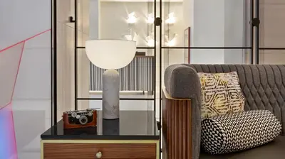 a room with a couch and a table with a camera at The Vibe on 5th Vibe 8750 in New York