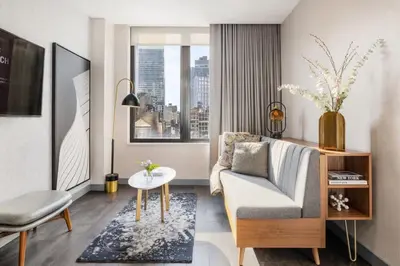 a living room with a couch and a table at The Vibe on 5th IV Vibe 8753 in New York