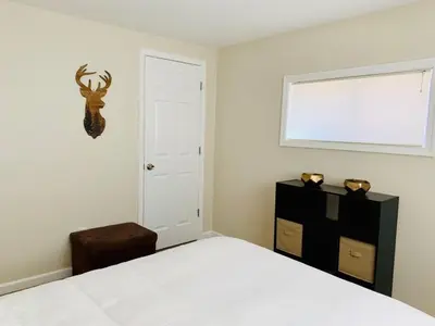 a bedroom with a white bed and a window at Beautiful Lakefront Chalet in the Poconos! in Hawley