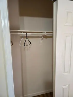 a closet with a pair of hangers in it at Honey queen room 5 in Newark