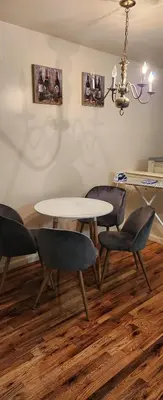 a dining room with a table and four chairs at Honey queen room 5 in Newark