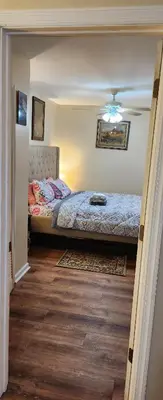 a bedroom with a bed in the corner of a room at Beautiful Room king in Newark