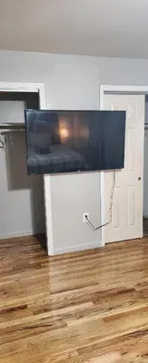 a flat screen tv sitting on a stand in a room at Beautiful Room king in Newark