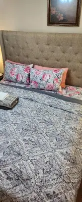 a bed with a headboard and pillows on it at Beautiful Room king in Newark