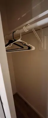 a white shelf in a room with a ceiling at Amazing family house in Newark