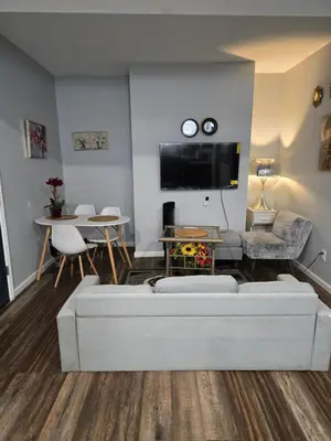 a living room with a couch and a table at Lemon king room 4 in Newark